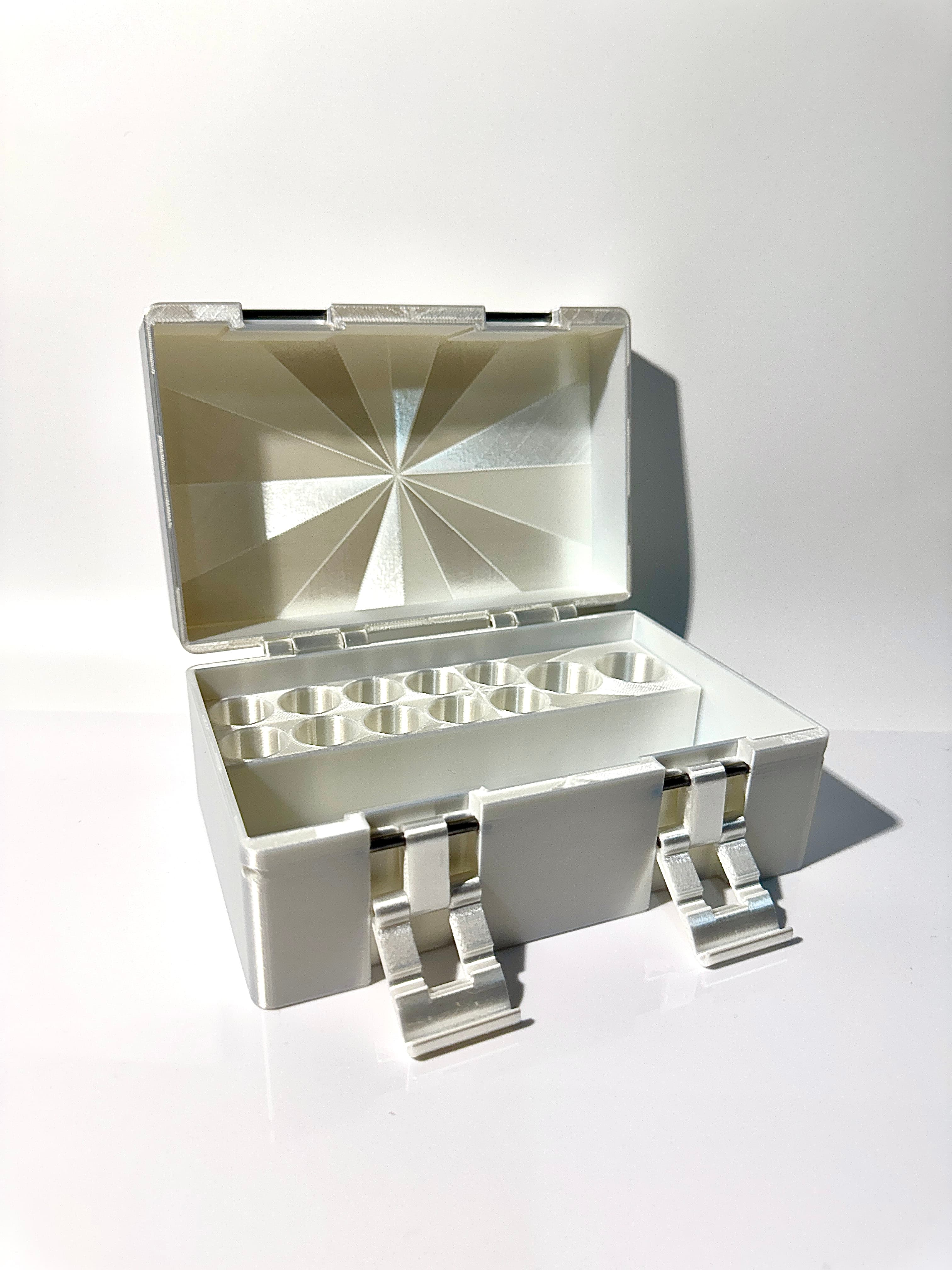 White pearl vial box fully open, showing starburst lid interior and vial rows